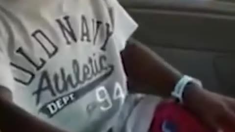 Black funny kid laughing in car
