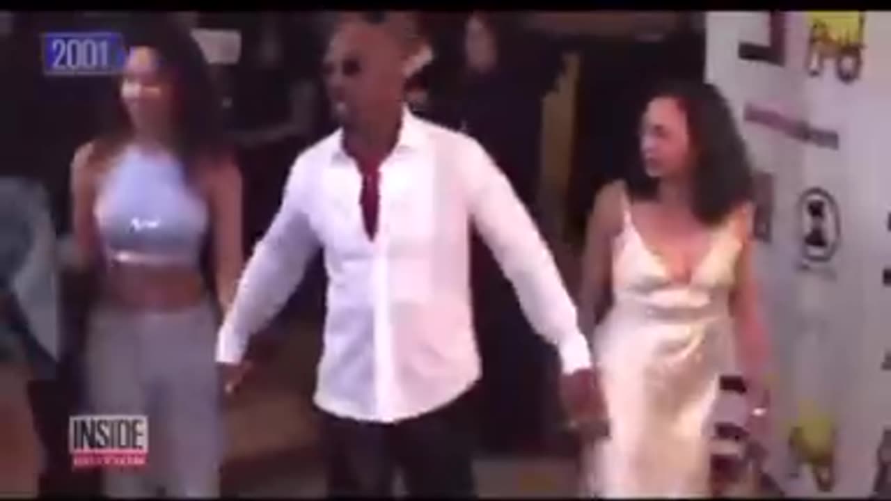 Montel Williams and his THOT Kamala Harris back in 2001. She...he...it has come a long way
