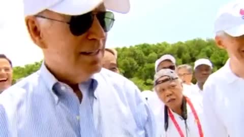 Joe Biden Caught On Camera Flirting With A Russian Man With 'Big Guns'