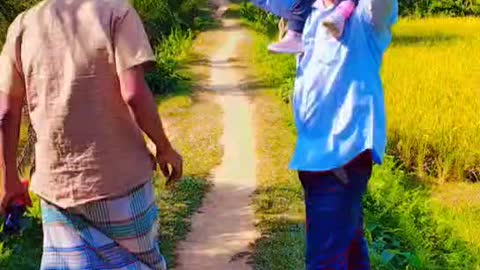 Walking in the village with my daughter and father.