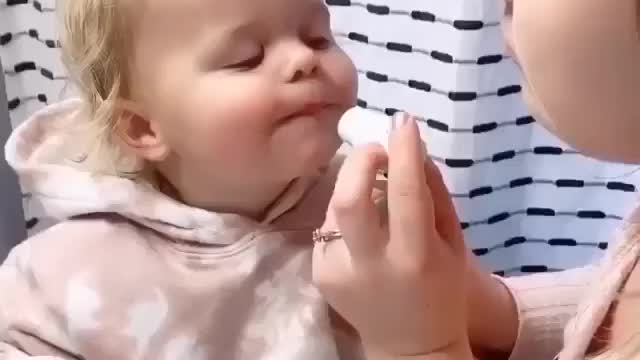 A mother baths her little daughter