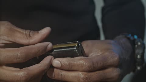 Man Putting Bullets in a Magazine