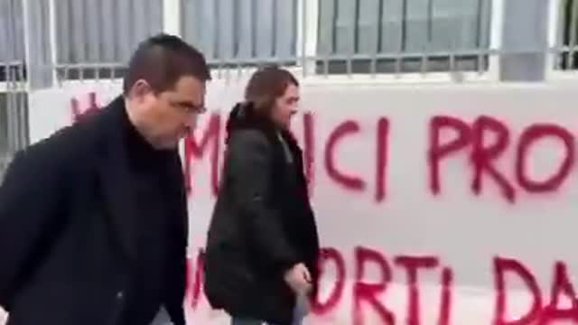 Italians use blood red spray paint on central health building over the Covid-19 bio-weapons symbol