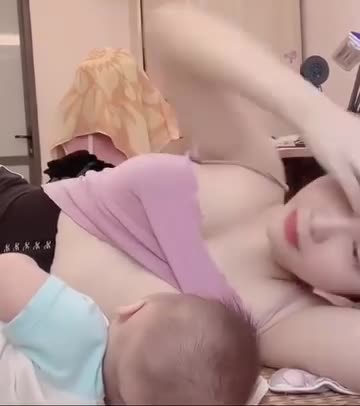 Beautiful Asian mom breastfeeding baby