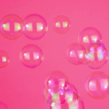 Bubbles floating on a pink background