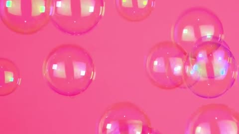 Bubbles floating on a pink background