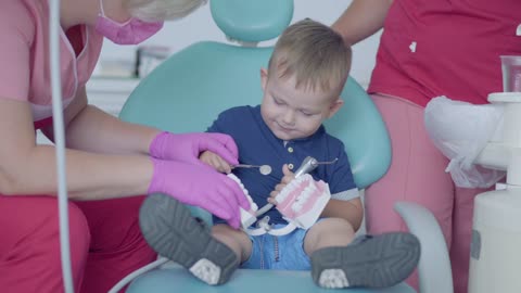 Playful boy in consultation with the dentist