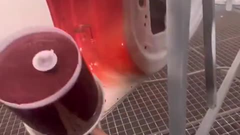 Spray a layer of red car paint on automotive sheet metal