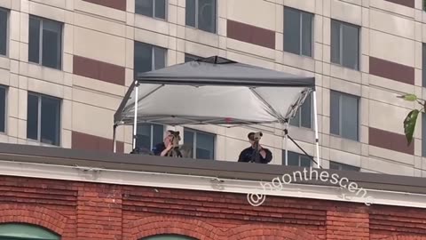 On one of the rooftops across from the main entrances to the Trump rally today