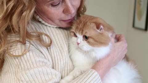A Woman Cuddling Her Cat