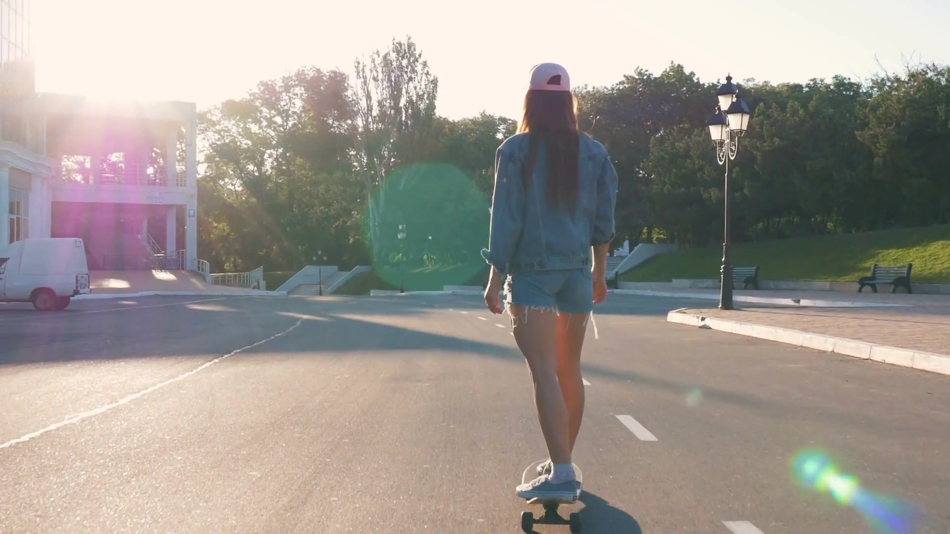 young stylish woman skateboarding