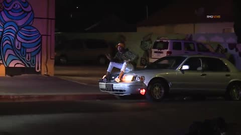 Guy Sits On Hood of Car While Getting Chased