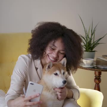 cute dog taking a selfi with mobikle phone