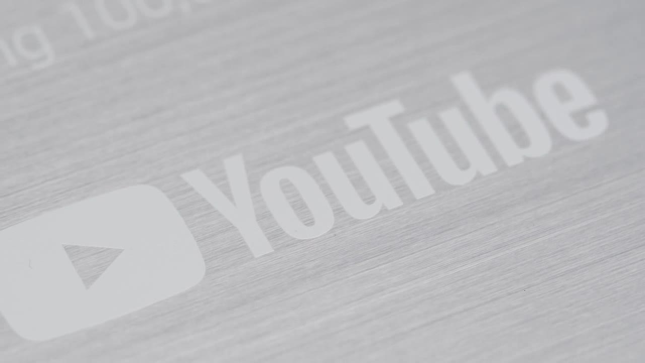 Extreme Close Up Shot of a YouTube 100,000 Subscriber Milestone Plaque Rotating