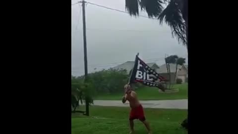 F Biden flags flying during hurricane Ian