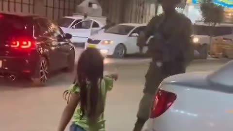 Palestinian children enthusiastically go to the Israeli soldiers and shake hands with them
