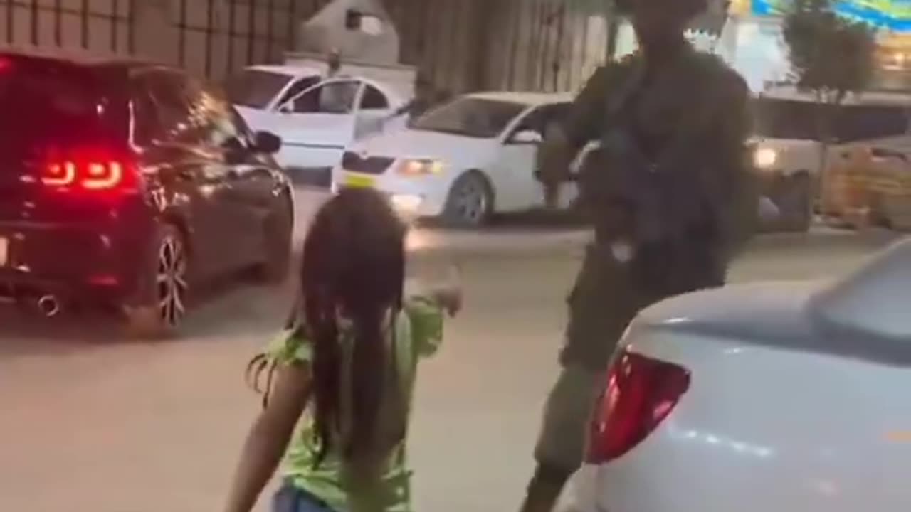 Palestinian children enthusiastically go to the Israeli soldiers and shake hands with them