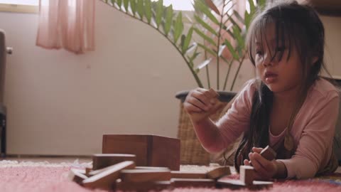 Cute Child Playing with Wooden Blocks
