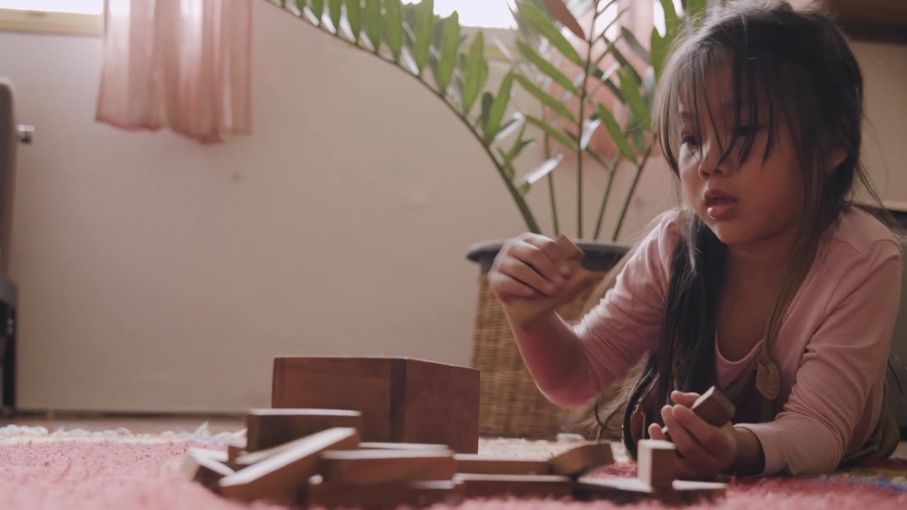 Cute Child Playing with Wooden Blocks