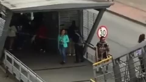 Hombre volando cometa en plena estación de Transmilenio