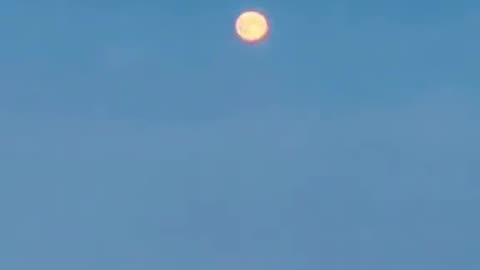 passenger films the local moon among the clouds