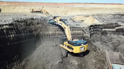 005. Excavators And Wheel Loaders Working On Huge Mining Areas - Mega Machines Movie