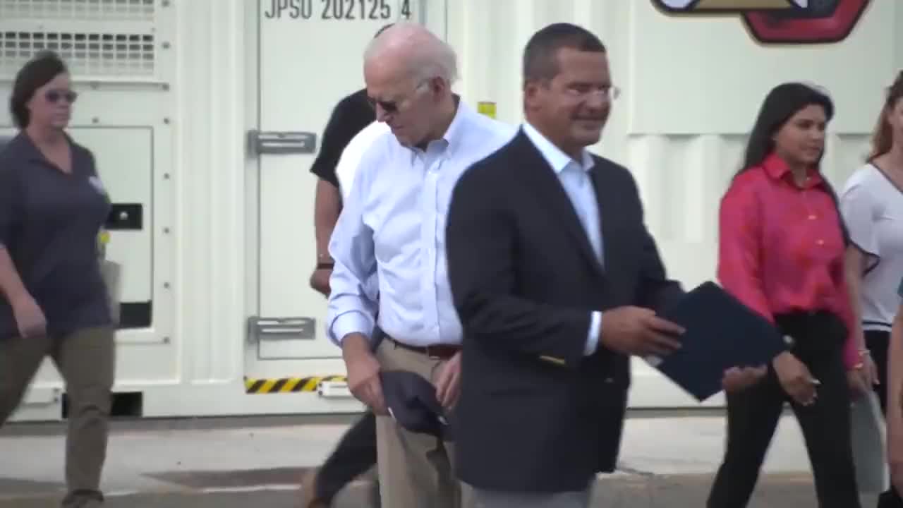 Biden appears to search for something on the floor.