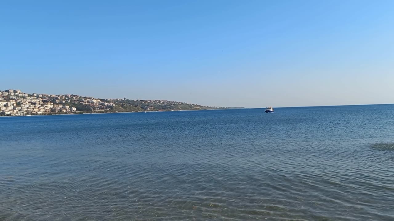 A beautiful view of the calm sea and a mountain in the distance