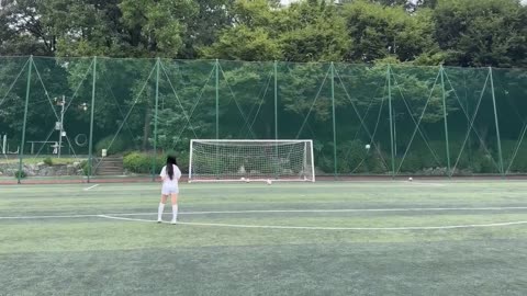 Girl Footballer Practising