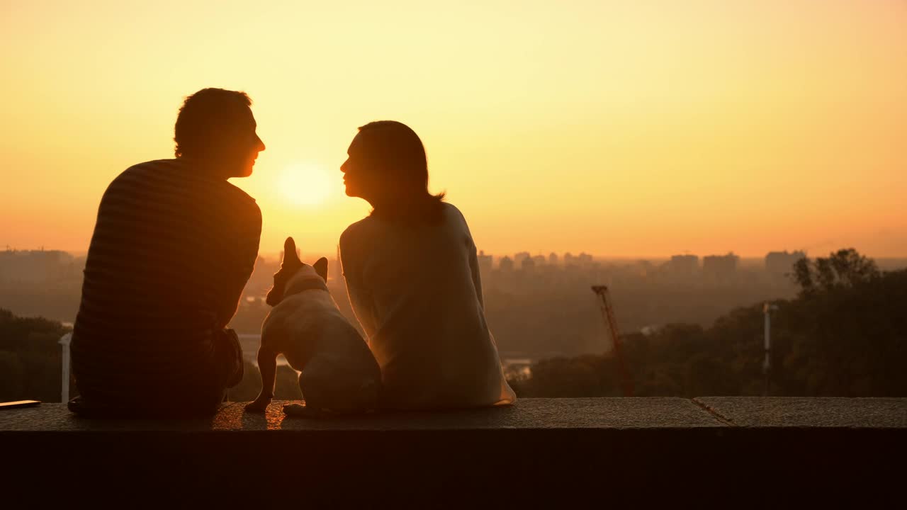 A couple in love watching a romantic sunset