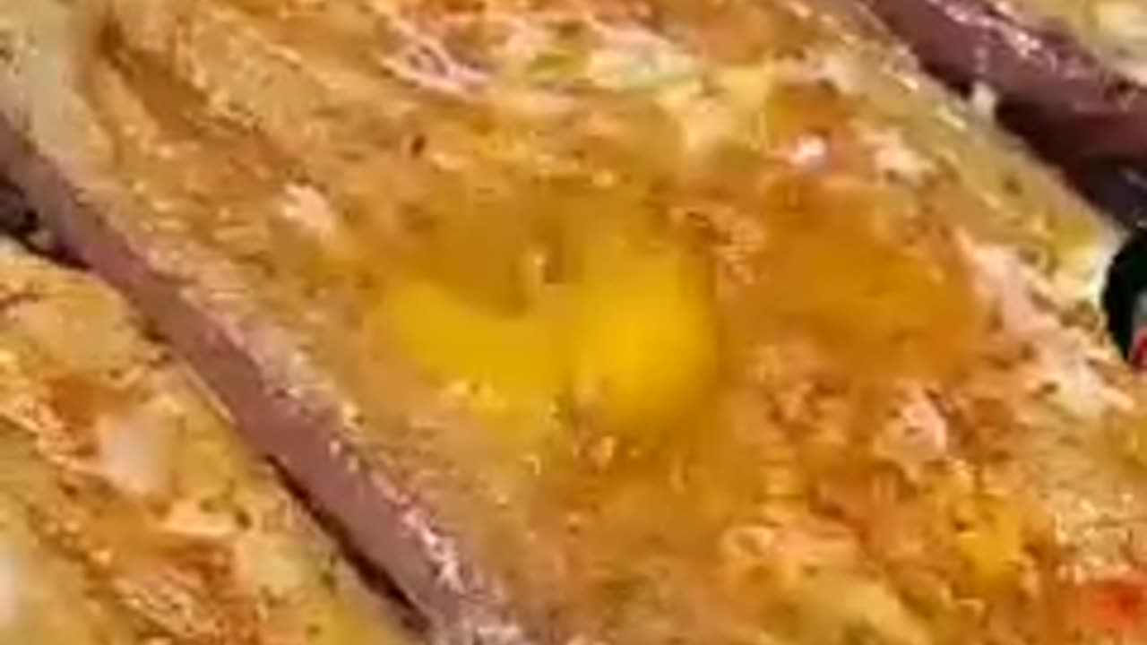Making spicy egg plant sprinkle spices green coriander and egg on it and cook it