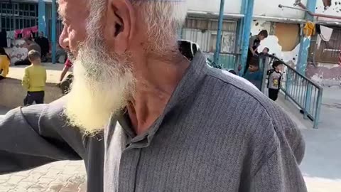 An elderly Palestinian man demands that water be provided to the children of...