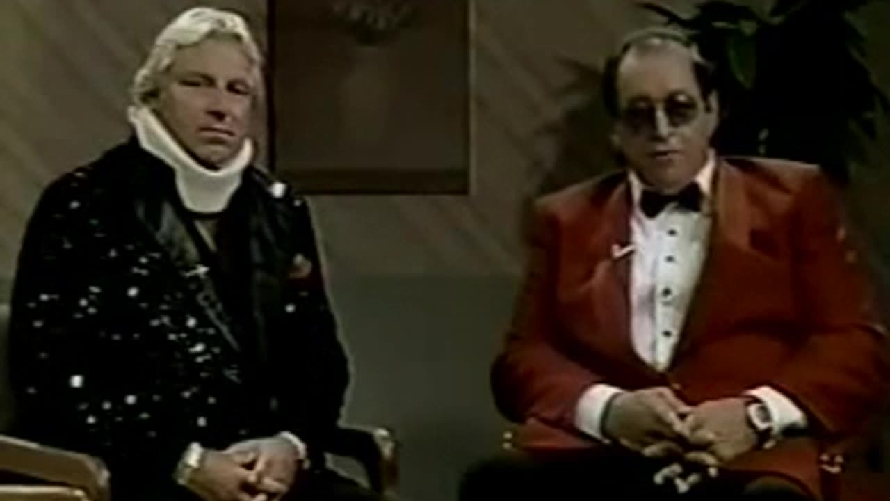 Gorilla Monsoon's Doctor examines Bobby Heenan's neck.
