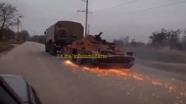 KamAZ drags its booty - already burned Ukrainian BRDM-2