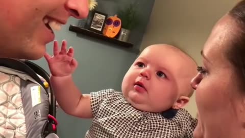 Baby gets emotional when Dad kisses Mum