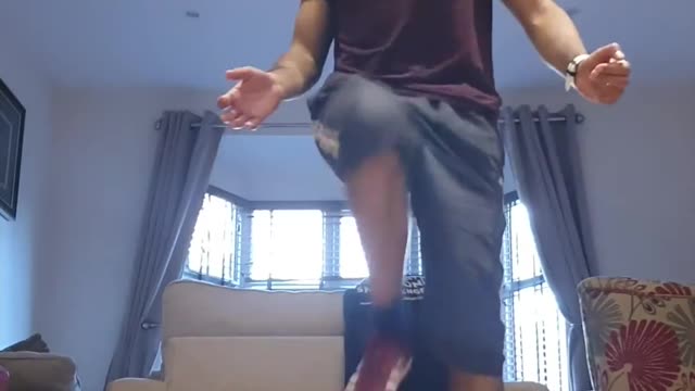 Guy Breaks Flower Vase While Juggling Football Inside House