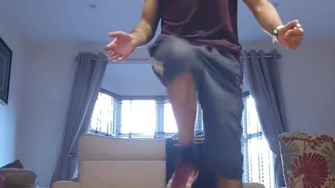 Guy Breaks Flower Vase While Juggling Football Inside House