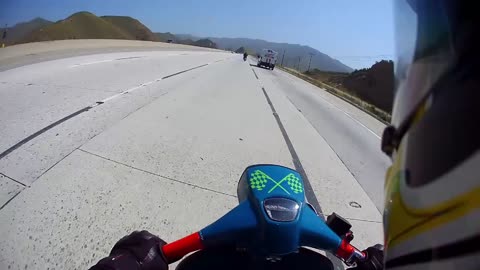 Vintage Scooters passing a Harley Davidson Van