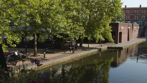 Panning Shot Of Elderly Man Walking Next To Canal In Birmi