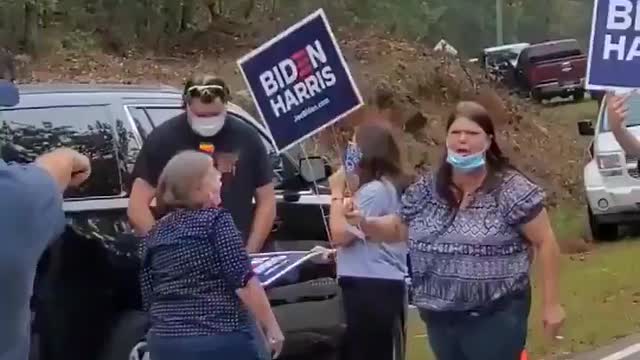 Trump supporter charged down by Biden supporter.