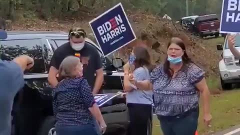 Trump supporter charged down by Biden supporter.