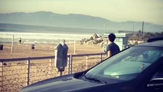 Man practicing stretches on beach