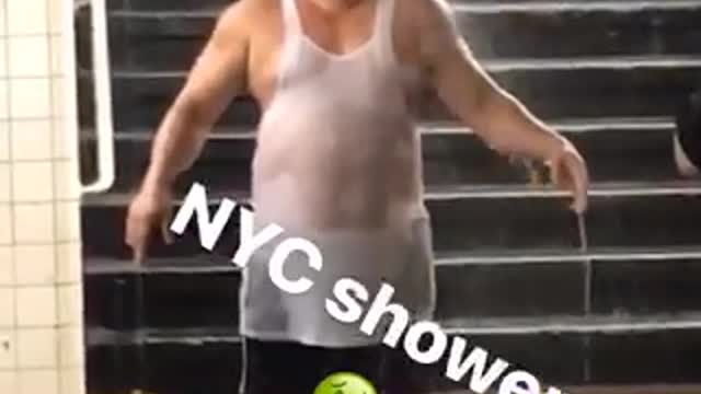 Nyc showers man stands under water falling in subway