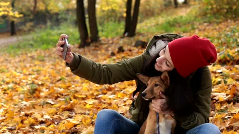 Woman taking a selfie with her dog