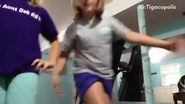 Music two girls dance to song one stands on table and falls down