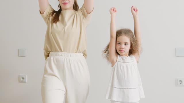 Mother and Daughter Exercising