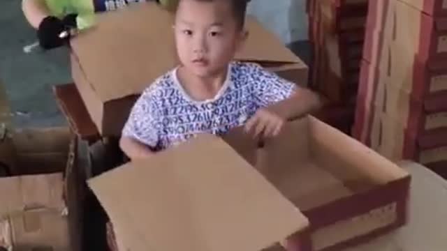 A Kid skillfully assembles a box