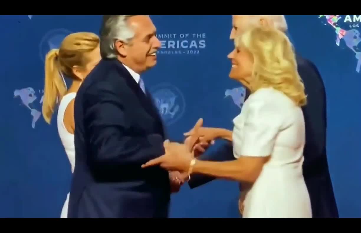 Joe Biden grab the President of Argentina's wife's hand and not let go