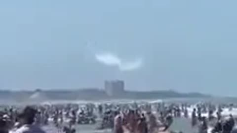 Beach full of people getting SPRAYED by Aircraft.