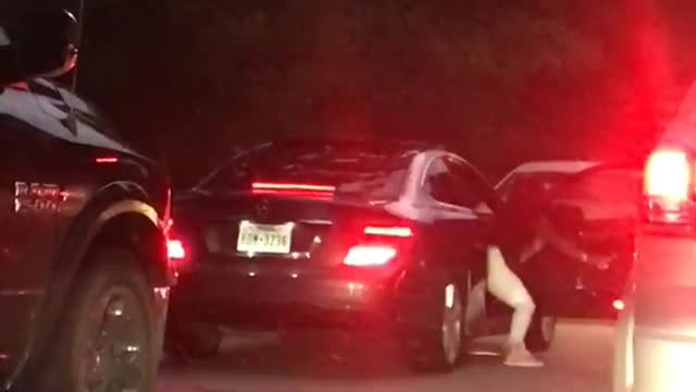 Girl dances during traffic